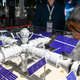 A photo of people looking at a model of a space station in Russia.